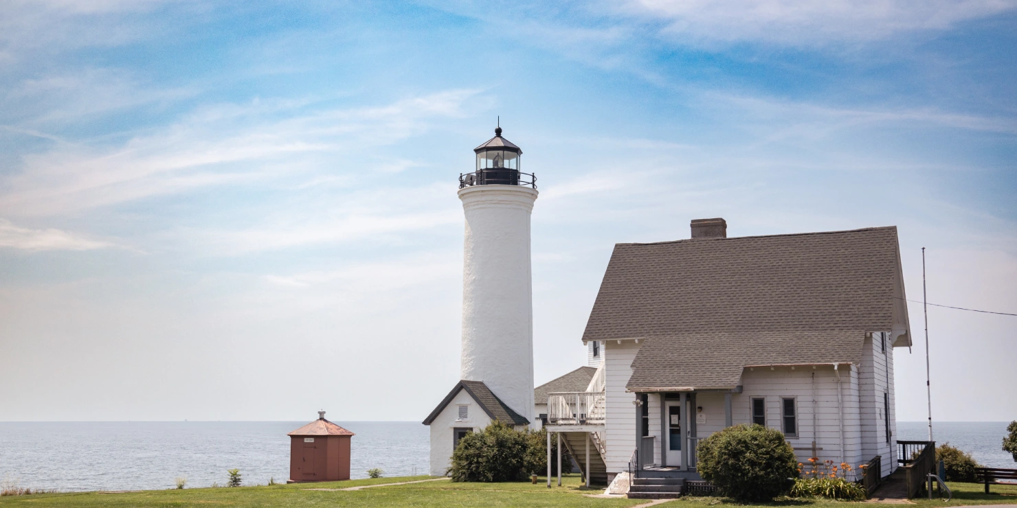 Coastal lighthouse with a nearby house