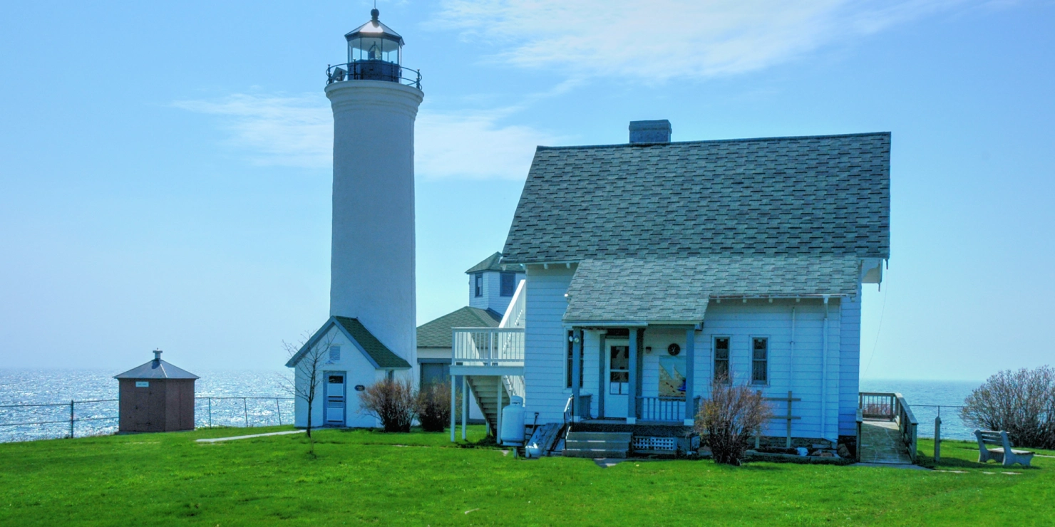 Lighthouse and house by the sea